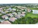 Aerial view of homes in a golf course community with ponds, landscaping, and golf course at 8354 Palmetto Ct, Englewood, FL 34224