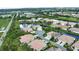 An aerial view of the beautiful neighborhood shows the community pond and common areas at 8354 Palmetto Ct, Englewood, FL 34224