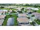 Aerial view of home and community with serene pond and landscaping at 8354 Palmetto Ct, Englewood, FL 34224