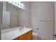 Bright bathroom featuring a large mirror, vanity with storage, and shower with tile surround at 8354 Palmetto Ct, Englewood, FL 34224