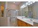 Well-lit bathroom with double sinks, glass shower, and modern fixtures at 8354 Palmetto Ct, Englewood, FL 34224