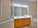 Bathroom with double sinks, soaking tub, and contemporary lighting fixtures at 8354 Palmetto Ct, Englewood, FL 34224