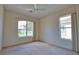 Bright bedroom featuring plush carpeting and abundant natural light from large windows at 8354 Palmetto Ct, Englewood, FL 34224