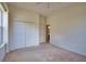 Bedroom with carpet, closet and doorway entrance to an adjacent bathroom at 8354 Palmetto Ct, Englewood, FL 34224