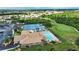 Aerial view of community featuring pool, clubhouse, parking, golf, and tennis courts at 8354 Palmetto Ct, Englewood, FL 34224
