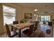 Dining room is staged with a rustic wood table set for six with a view to the living room at 8354 Palmetto Ct, Englewood, FL 34224