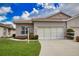 Inviting one-story home with a tile roof, lush lawn and an attached two-car garage at 8354 Palmetto Ct, Englewood, FL 34224