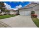 Well-maintained home featuring a spacious driveway and attached two-car garage at 8354 Palmetto Ct, Englewood, FL 34224