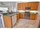 Bright kitchen with stainless steel appliances, tile floors and bar seating at 8354 Palmetto Ct, Englewood, FL 34224