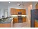 Bright kitchen featuring stainless steel appliances, tile floor, and ample cabinet space with modern hardware at 8354 Palmetto Ct, Englewood, FL 34224