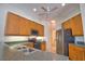 Well-lit kitchen features stainless steel refrigerator, range and microwave and tile flooring at 8354 Palmetto Ct, Englewood, FL 34224