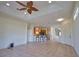 View of the open floor plan with a kitchen bar and chairs, seamlessly connecting living spaces at 8354 Palmetto Ct, Englewood, FL 34224