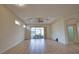 Open living room featuring tile flooring, ceiling fan and glass sliding door leading to outdoor patio at 8354 Palmetto Ct, Englewood, FL 34224
