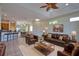 Comfortable living room is furnished with leather seating and has a clear sight line to the breakfast bar and dining room at 8354 Palmetto Ct, Englewood, FL 34224