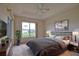Comfortable main bedroom featuring a tray ceiling and a large window with a view at 8354 Palmetto Ct, Englewood, FL 34224