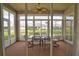 Relax in this sunroom with views of the pond and community at 8354 Palmetto Ct, Englewood, FL 34224