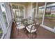 A cozy sunroom is perfect for relaxing with views of the pond and community at 8354 Palmetto Ct, Englewood, FL 34224
