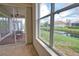 View from the interior sunroom to the outside seating area and pond at 8354 Palmetto Ct, Englewood, FL 34224