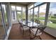 Enjoy outdoor dining in this beautiful sunroom with views of the pond and community at 8354 Palmetto Ct, Englewood, FL 34224
