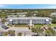 Low aerial view of the apartment complex with parking and well-manicured landscaping at 8396 111Th St # 301, Seminole, FL 33772