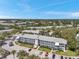 Aerial view of the apartment complex showing parking, landscaping, and the surrounding community at 8396 111Th St # 301, Seminole, FL 33772
