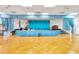 Large auditorium with polished parquet floors, a stage with blue curtains, and American flag at 8396 111Th St # 301, Seminole, FL 33772