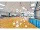 Expansive auditorium with parquet floors, tables and chairs, and a stage with blue accents at 8396 111Th St # 301, Seminole, FL 33772