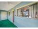 Enclosed patio features a ceiling fan, large window with curtains, and a view to the exterior at 8396 111Th St # 301, Seminole, FL 33772