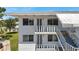 Charming condo building with a staircase and balcony, providing a welcoming entrance and outdoor space at 8396 111Th St # 301, Seminole, FL 33772