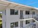 The exterior elevation of the apartment complex showing the balconies, staircases, and entry doors at 8396 111Th St # 301, Seminole, FL 33772