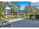 Community patio with grill, tables, chairs and landscaping, perfect for outdoor gatherings and relaxation at 8396 111Th St # 301, Seminole, FL 33772