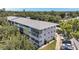 Corner aerial view of the apartment complex with parking and landscaping in the foreground at 8396 111Th St # 301, Seminole, FL 33772