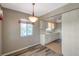 Kitchen and dining area with white cabinets, new floors, and lighting at 8396 111Th St # 301, Seminole, FL 33772