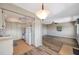 Open kitchen view into living room with ceiling fans and light wood cabinets at 8396 111Th St # 301, Seminole, FL 33772
