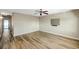 Empty living room featuring wood-look floors, ceiling fan, and neutral paint at 8396 111Th St # 301, Seminole, FL 33772