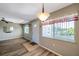 Inviting living room with wood floors, large window, and a charming light fixture at 8396 111Th St # 301, Seminole, FL 33772