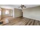 Living room view into kitchen featuring wood-look floors and neutral walls at 8396 111Th St # 301, Seminole, FL 33772