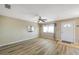 Empty living room showcasing wood-look floors and a ceiling fan at 8396 111Th St # 301, Seminole, FL 33772