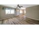 Living room featuring wood-look floors, ceiling fan, window and neutral walls at 8396 111Th St # 301, Seminole, FL 33772