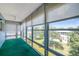 Sunroom with floor to ceiling windows with blinds providing natural light and a lush green outdoor view at 8396 111Th St # 301, Seminole, FL 33772