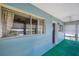 Sunroom with blue walls, green carpet, and window with curtains providing natural light at 8396 111Th St # 301, Seminole, FL 33772