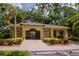 Community clubhouse with attractive landscaping and paver-stone entry at 9317 Stone River Pl, Riverview, FL 33578