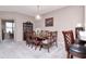 Formal dining area with elegant lighting, a large wooden table, and seating for eight at 9317 Stone River Pl, Riverview, FL 33578