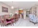 Open-concept dining area with an elegant wooden table, a large window, and natural light at 9317 Stone River Pl, Riverview, FL 33578