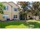 Home exterior with a backyard, mature tree, and screened lanai at 9317 Stone River Pl, Riverview, FL 33578