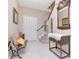 Bright foyer with tile flooring, stairs, bench, console table and neutral decor at 9317 Stone River Pl, Riverview, FL 33578