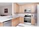 Kitchen with stainless steel appliances and light wood cabinets at 9317 Stone River Pl, Riverview, FL 33578