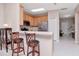 Kitchen with stainless steel appliances, light wood cabinets, and breakfast bar at 9317 Stone River Pl, Riverview, FL 33578