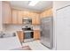 Bright kitchen with stainless steel appliances and light wood cabinets at 9317 Stone River Pl, Riverview, FL 33578