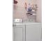 Functional laundry area with washer, dryer, and storage shelves at 9317 Stone River Pl, Riverview, FL 33578